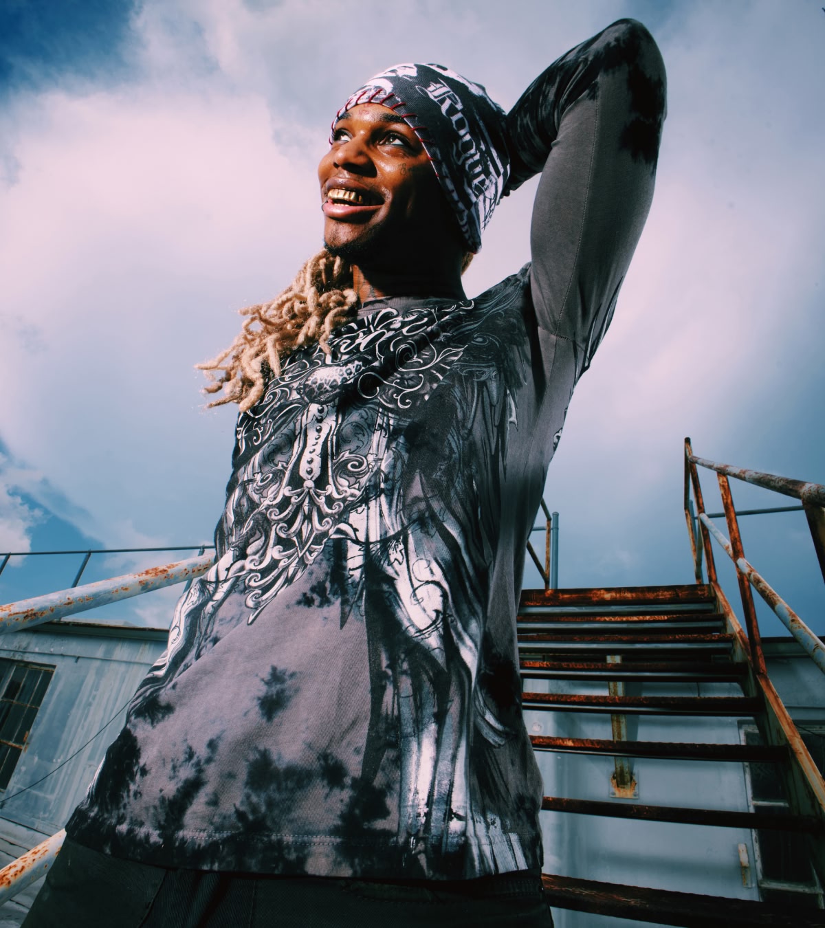 Shop Affliction x Rogue | A man facing to the sky, wearing an Affliction beanie and a tee from the collab