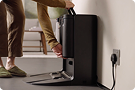 A Dyson robot dock is assembled and plugged in.