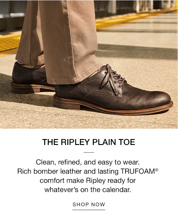Close-up of brown Ripley Plain Toe shoes worn with tailored pants at a Metro station. Text reads: 