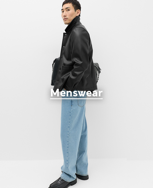 Man wearing black Faux Leather Chore Jacket with Denim Jeans