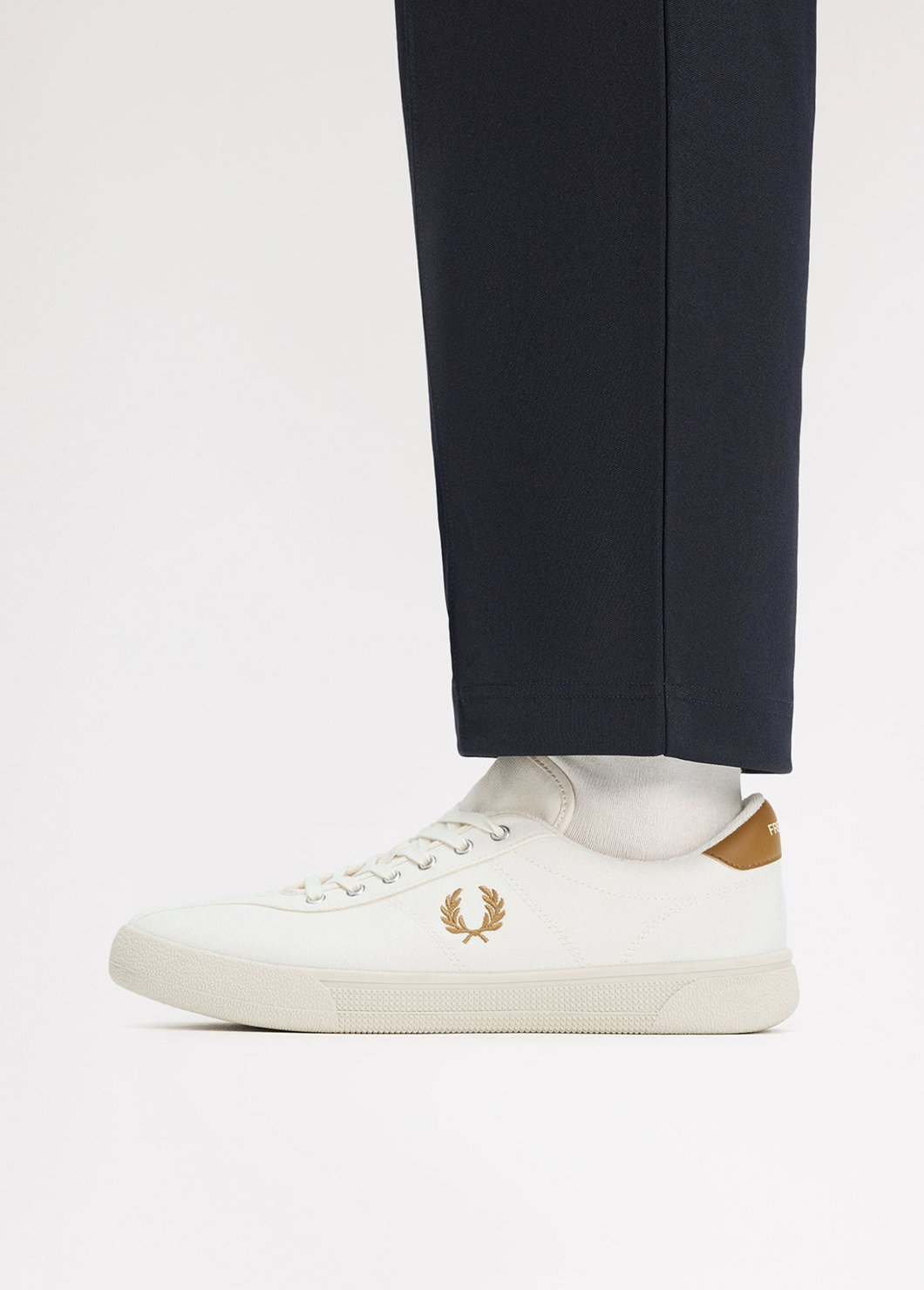 Close up of a Fred Perry Canvas Tennis Shoe in Ecru / Dark Caramel