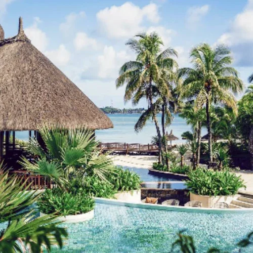 hotel with pool and thatched roof outdoor bar