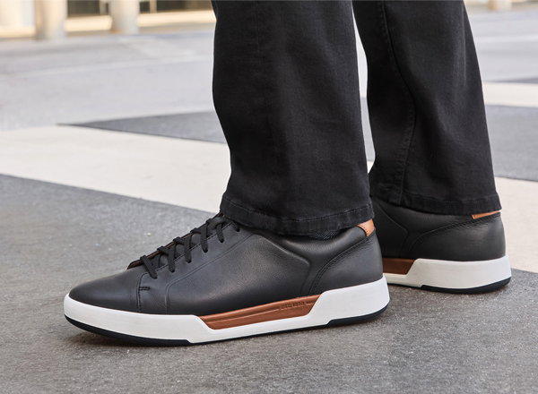 Close-up of black Kendall Lace-to-Toe sneakers with white and brown sole details.