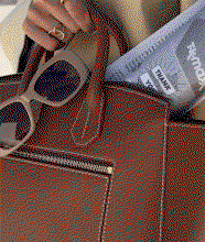 GIF of a brown leather handbag with sunglasses.
