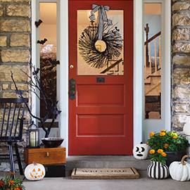 Front door with black bat wreath.