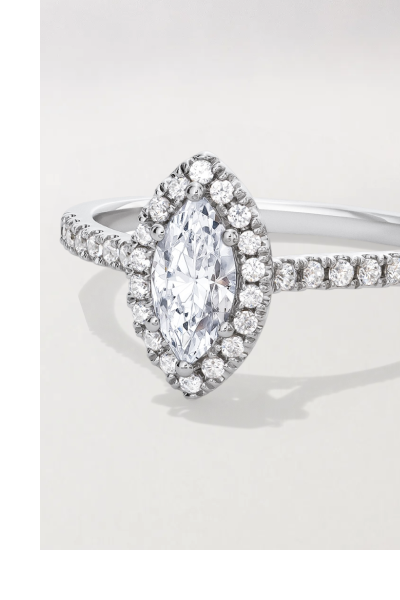 White gold engagement ring with a marquise-cut diamond and halo.