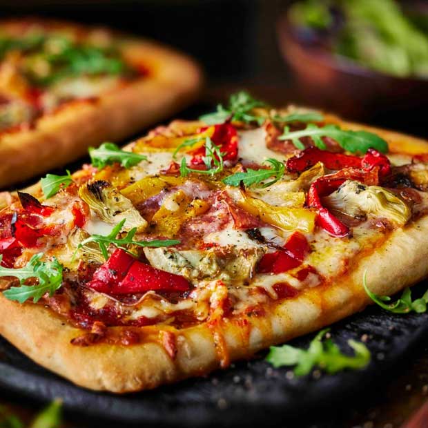 Salami, pepper and artichoke pizza