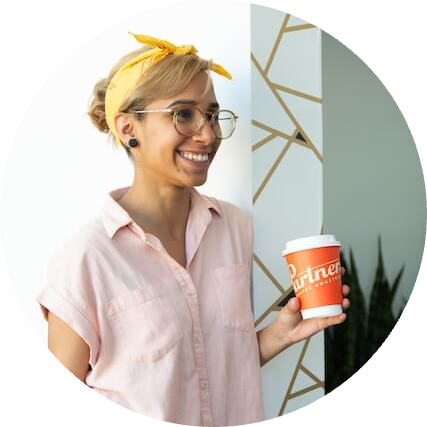 Photo of Raina R holding Partners Coffee cup