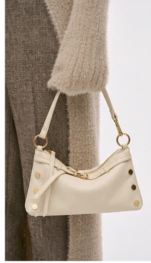 Kyle bag in Belted Parchment with gold hardware styled with a soft neutral fall outfit.