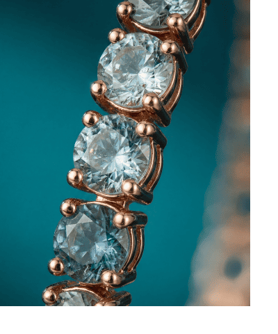 Rose gold bracelet with alternating round blue sapphires and diamonds.