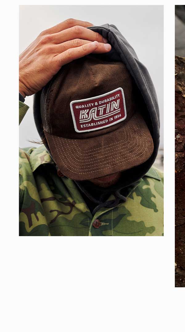 Model looking down wearing Pit Stop Trucker Hat.