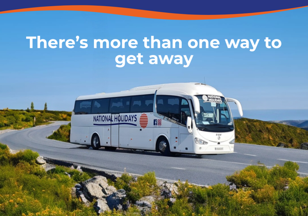 A coach bus labelled 'National Holidays' driving along a scenic winding road.