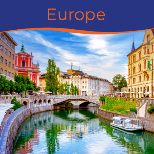 A scenic view of a European river with historic buildings and a bridge under a blue sky.