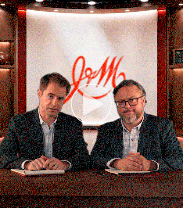 Animated image of Terry and Stan seated behind the Style Center desk with the Johnston & Murphy logo in the background and a play button overlay.