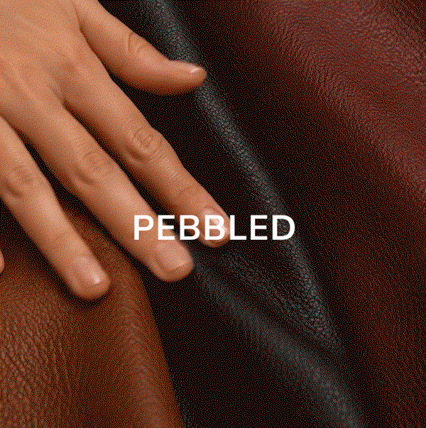 Animated close-up of a hand moving across dark brown pebbled leather, highlighting its textured finish, with “PEBBLED” displayed on screen.