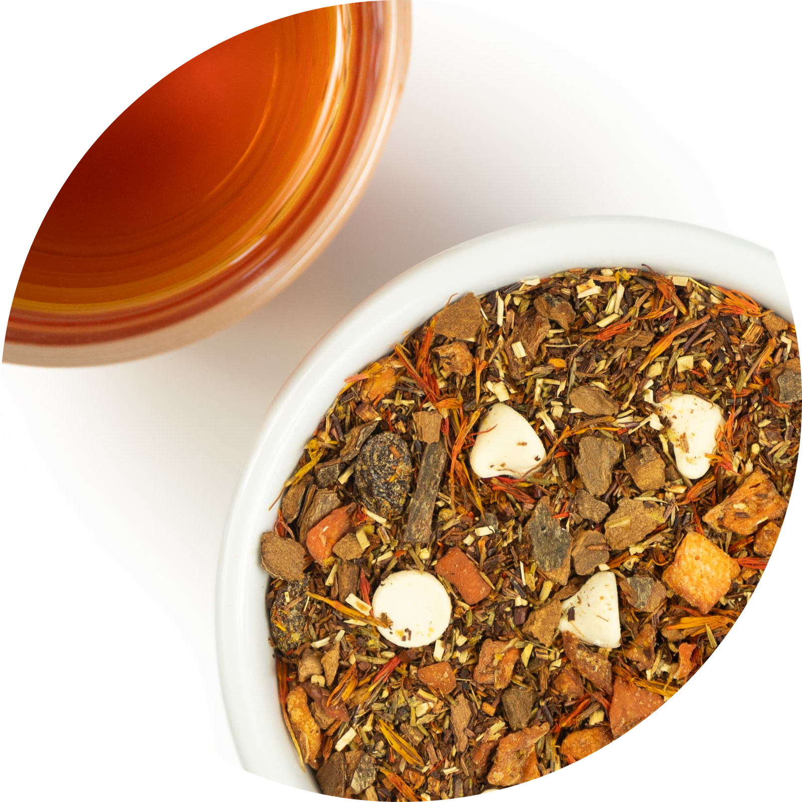 Mound of loose leaf pumpkin cheesecake tea next to a brewed cup