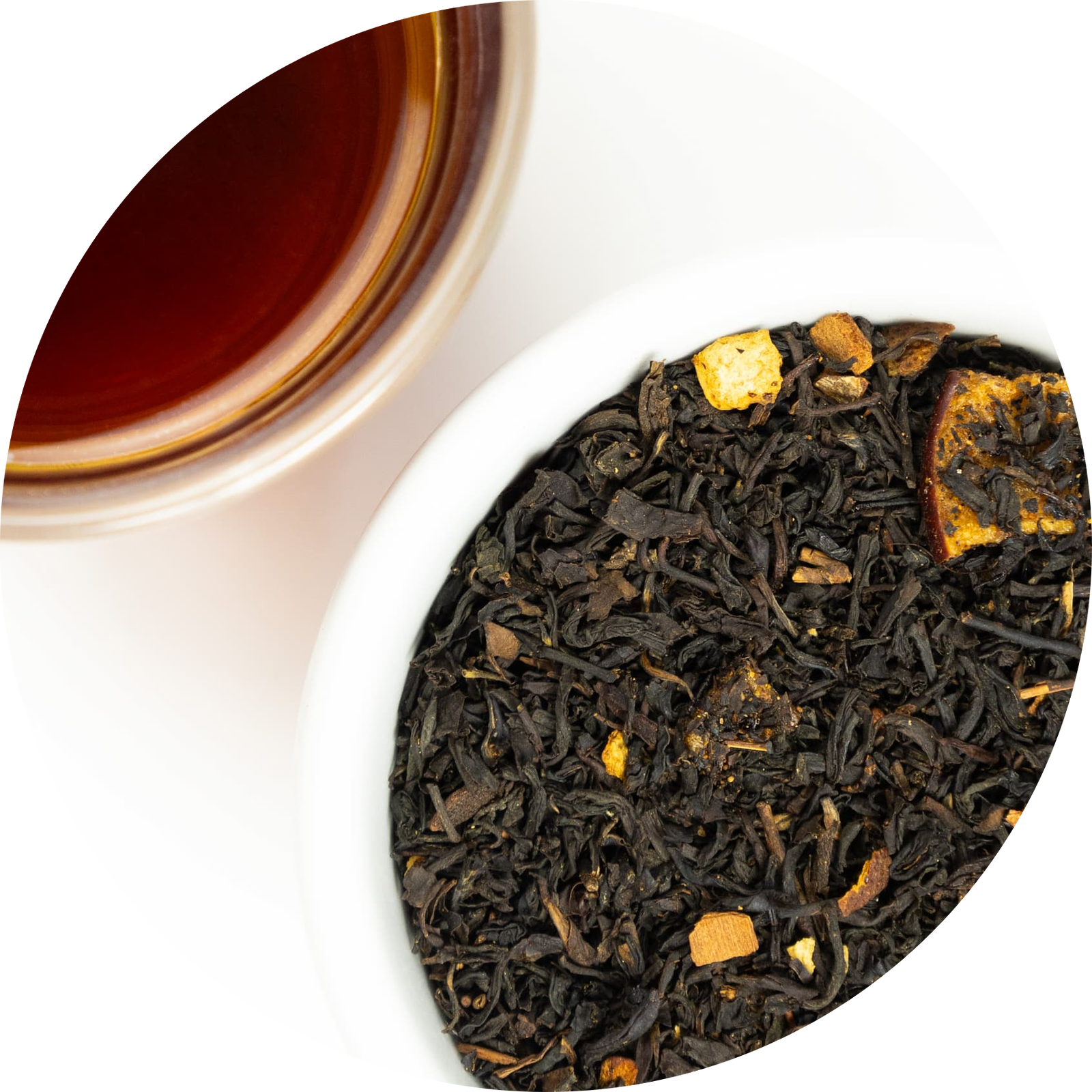 Mound of loose leaf apple cider donut tea next to a brewed cup
