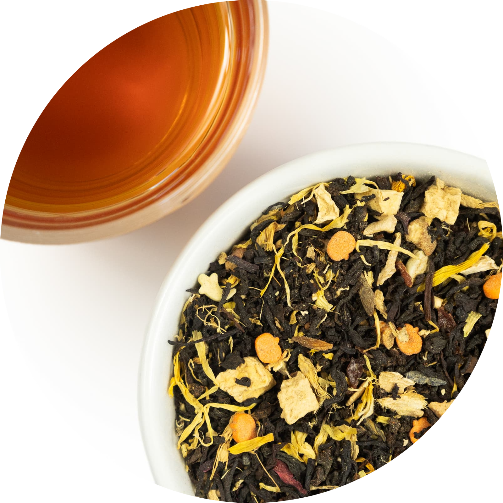 Mound of loose leaf pumpkin chai tea next to a brewed cup