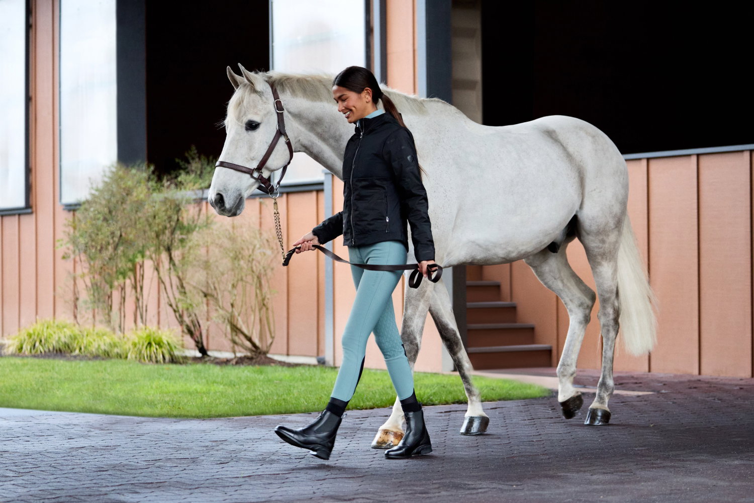 Women with horse in equestrian outfit.