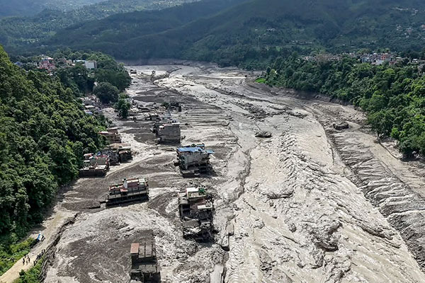 Houses are partially submerged in muddy water following flash floods in Nepal. 
