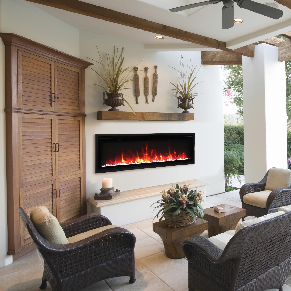 Cozy outdoor patio with chairs and electric fireplace.