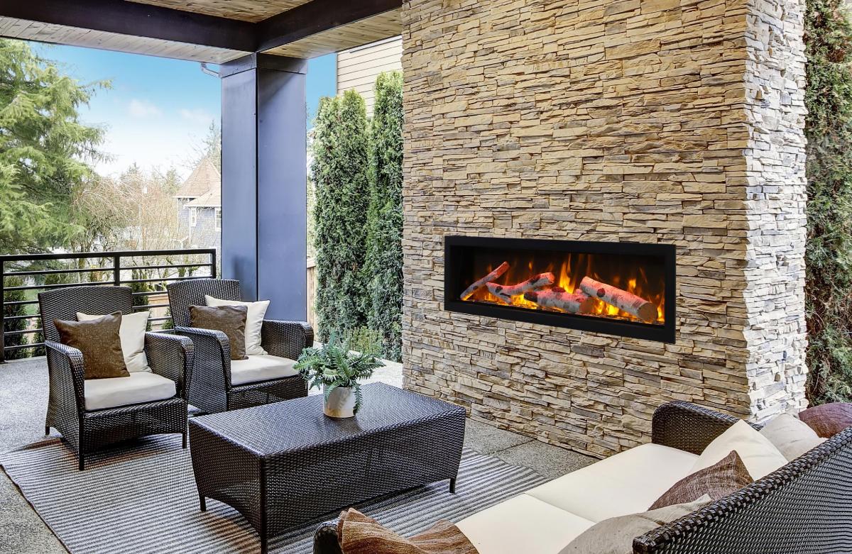 Outdoor patio with wicker furniture and fireplace.