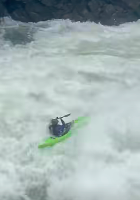 Kayaker dropping waterfall