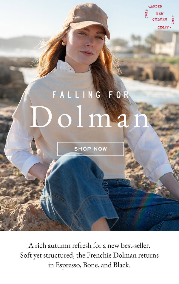 Falling for Dolman - Shop now - A risch autumn refresh for a new best-seller. Soft yet structured, the Frenchie Dolman returns in Espresso, Bone, and Black. - Image of a woman sitting on a beach wearing a cream French terry Dolman top.