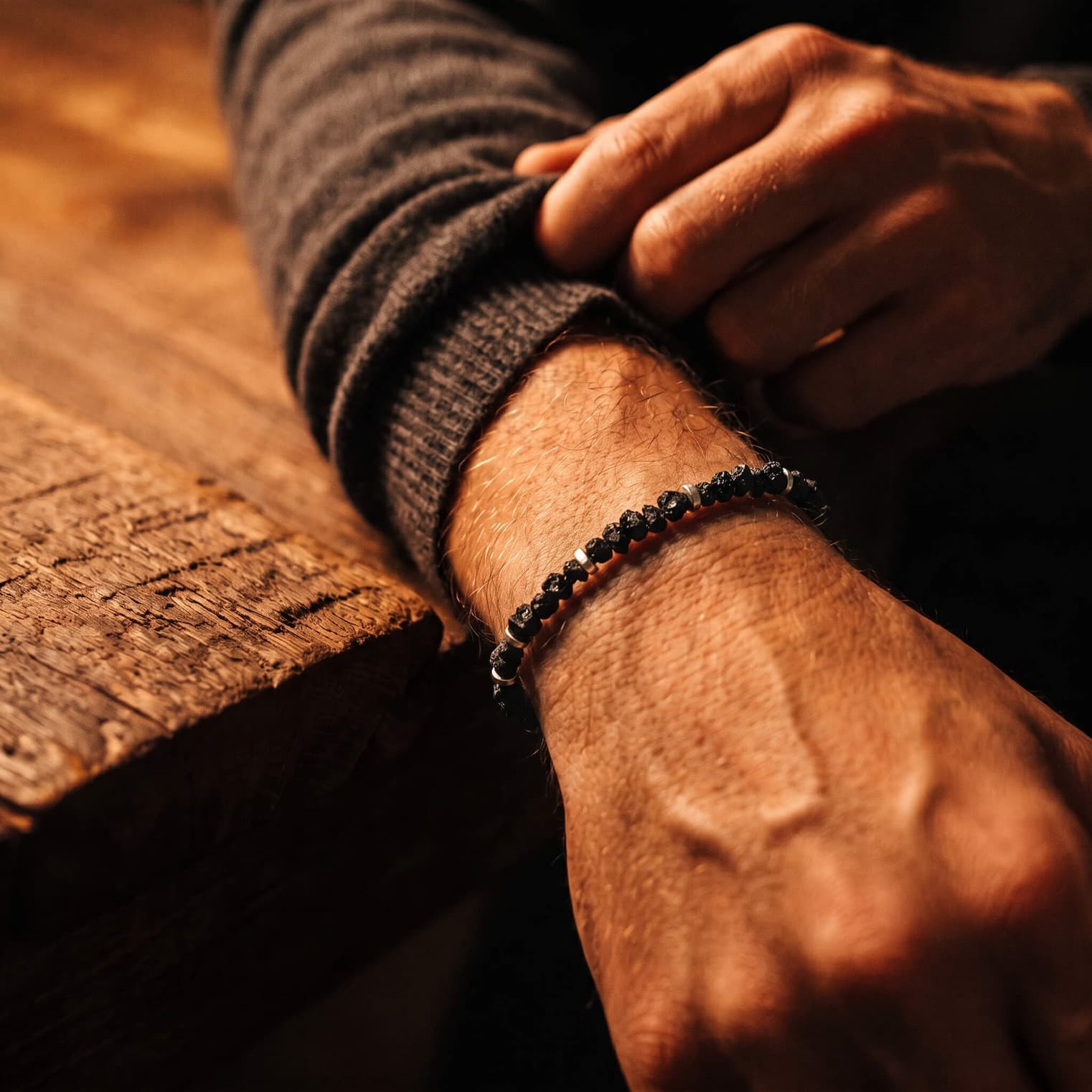 Raw black diamond bracelet worn on the wrist