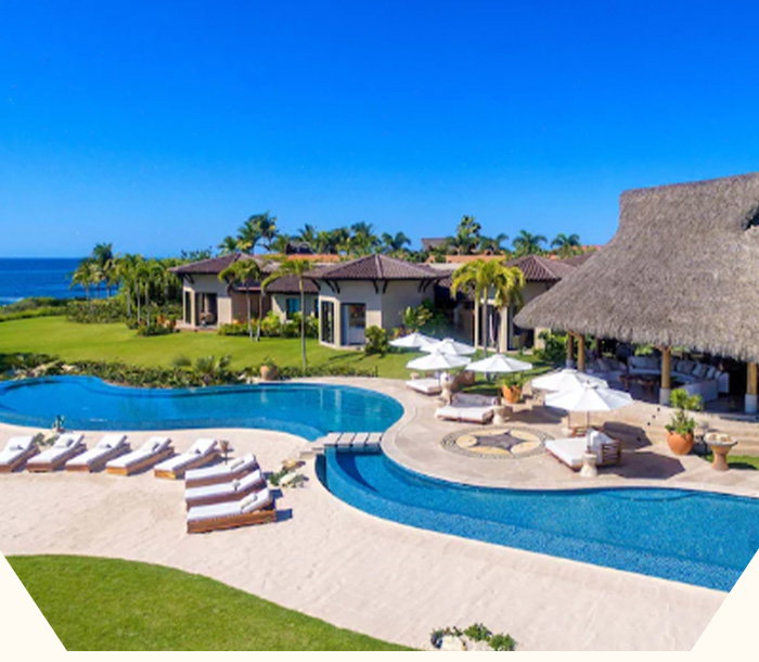 Sweeping oceanfront villa with curving pools, sun-drenched terraces, and endless blue horizons.