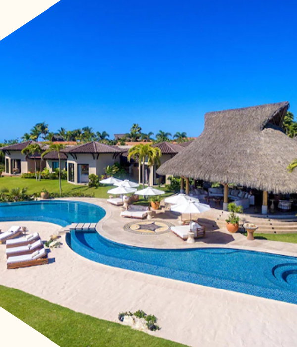 Sweeping oceanfront villa with curving pools, sun-drenched terraces, and endless blue horizons.