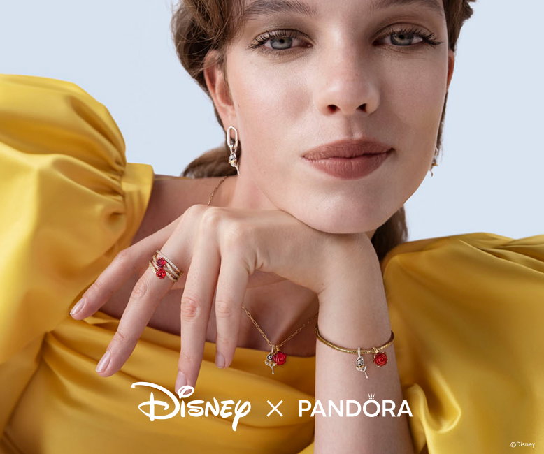 Model wears Pandora x Disney jewelry