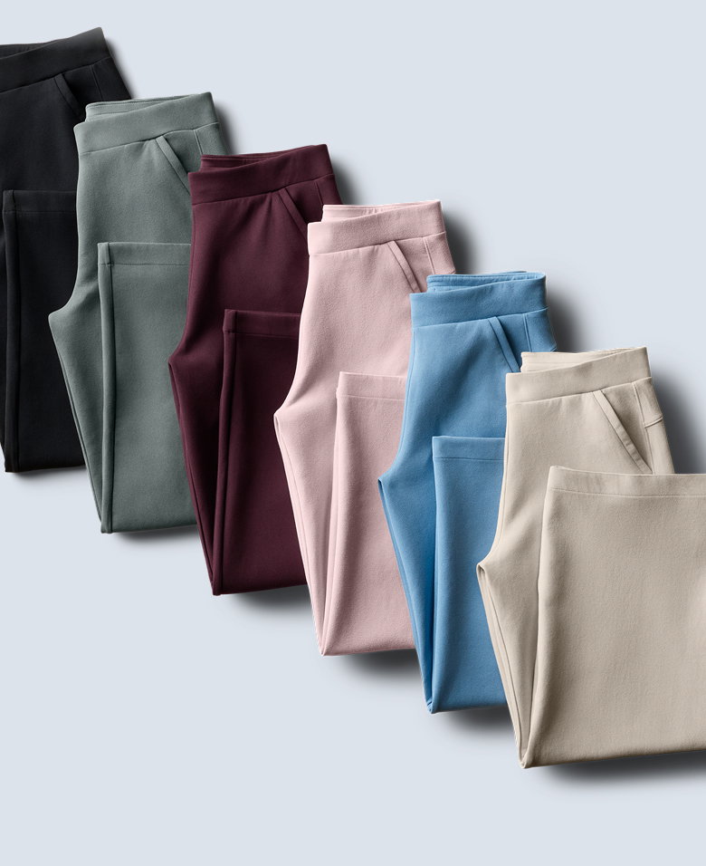 A flatlay of colorful sweat pants against a gray background.