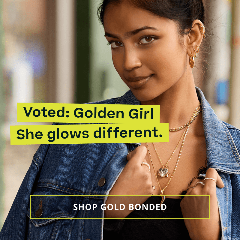 Model wearing gold ear stack & chains with dangling pendants. Voted: Golden Girl. Click here to shop gold bonded