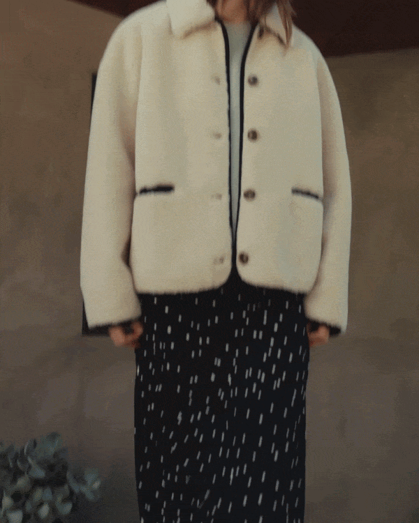 Model wearing Anika Teddy Jacket in Cream Black. 