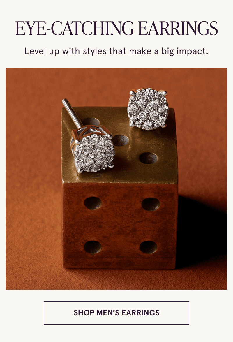 A pair of multi diamond earrings rest on a dice. Styles that make a big impact. Click here to shop men’s earrings