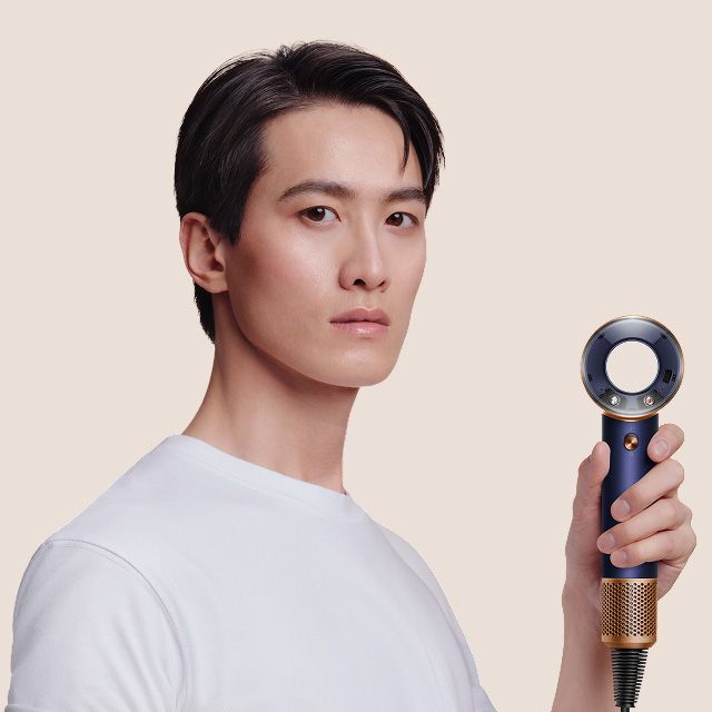 Model with sleek styled hair, achieved using the Dyson Supersonic Travel hair dryer.