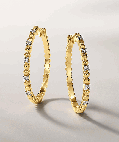 Yellow gold diamond hoop earrings.