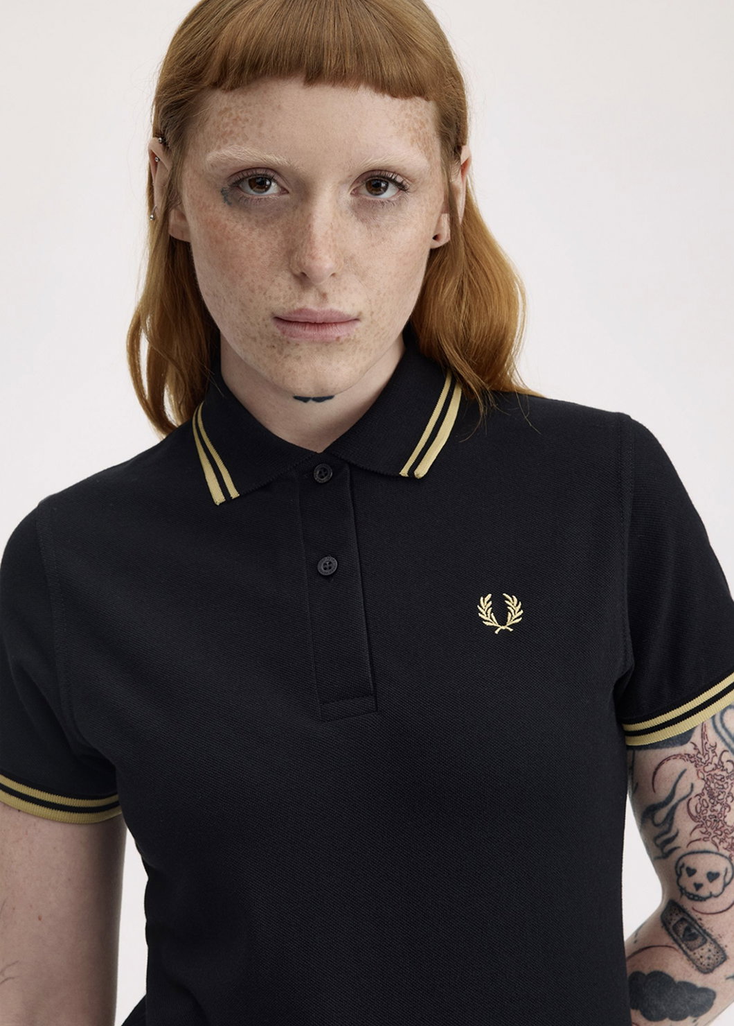 Female model wearing a G12 Fred Perry Shirt in Black / Champagne / Champagne