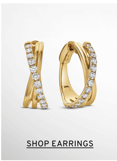 A pair of diamond crossover hoop earrings. Click to Shop Earrings