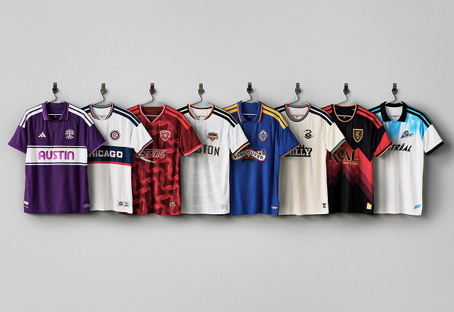 Eight MLS archive jerseys displayed on wall hooks against a gray background, showcasing vintage-inspired club designs from Austin FC, Chicago Fire, Toronto FC, Houston Dynamo, Vancouver Whitecaps, Philadelphia Union, Real Salt Lake, and CF Montréal.