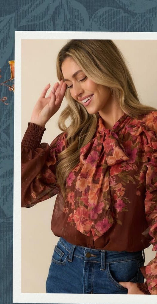 Model wearing a red floral long sleeve blouse.