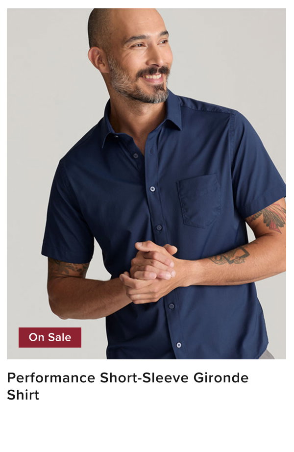 Model is wearing UNTUCKit blue performance short-sleeve gironde shit. 