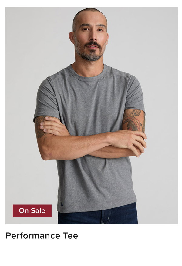 Model is wearing UNTUCKit performance tee in gray. 
