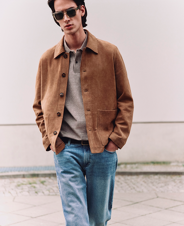 Man wearing Authentic Relaxed Straight Fit Rigid Jeans in Medium Blue with Suede Chore Jacket in Tan