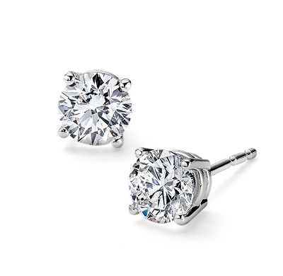Round brilliant diamond stud earrings set in white gold four-prong settings.