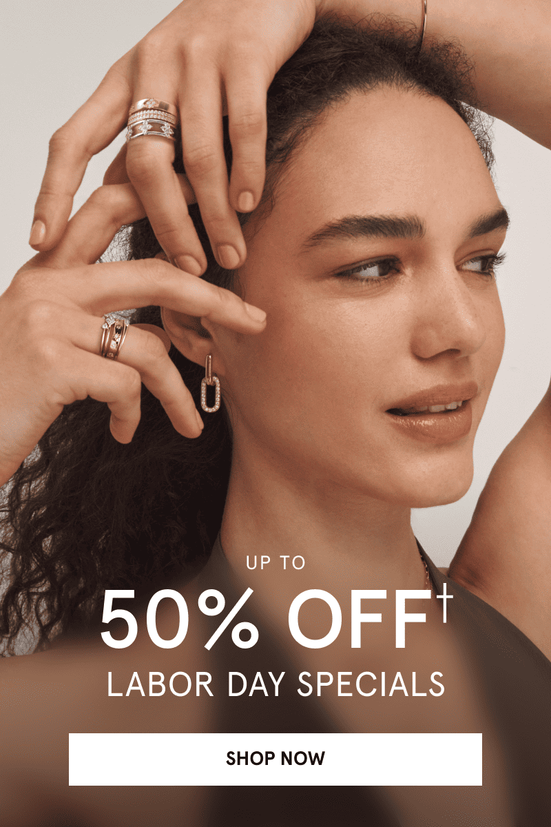 A model wearing gold rings and diamond oval hoop earrings. Up to 50% off Labor Day specials. Click shop now.
