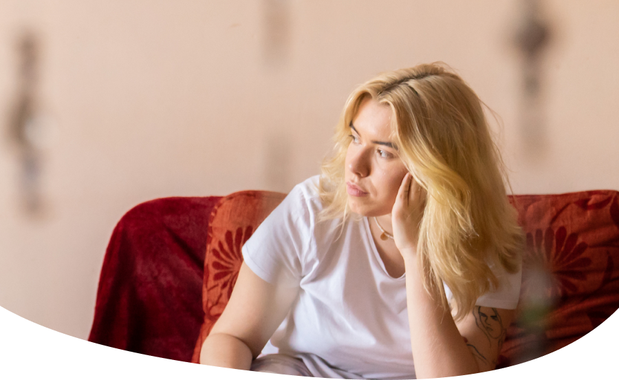 Person sitting on couch, looking out window