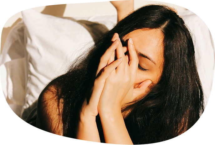 Woman with head in hands