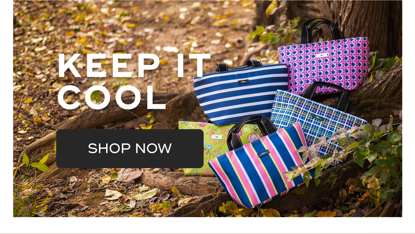 KEEP IT COOL. SHOP NOW. SCOUT bags in various patterns arranged on a tree root in a forest setting.